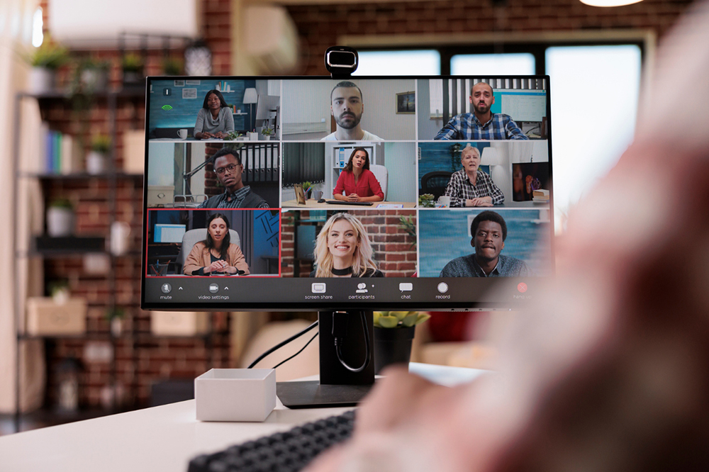 Online symposium displayed on a desktop monitor